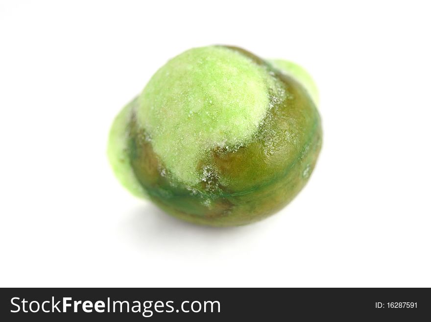 Macro shot of a wasabi coated green peas isolated on white background.