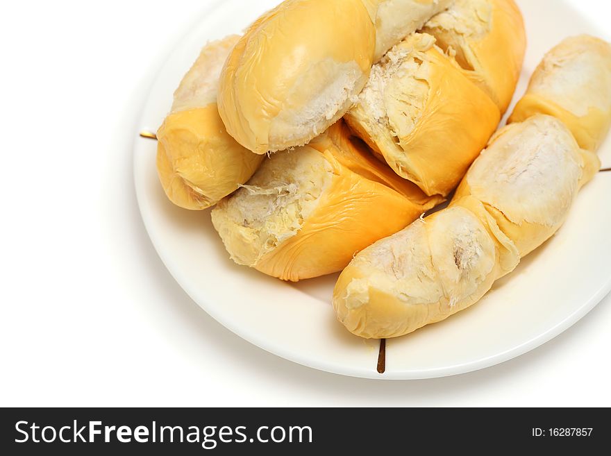 Close up of peeled durian flesh on white plate isolated over white background.