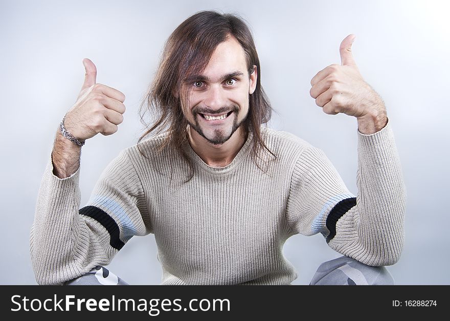 Energy young man holds fingers upwards