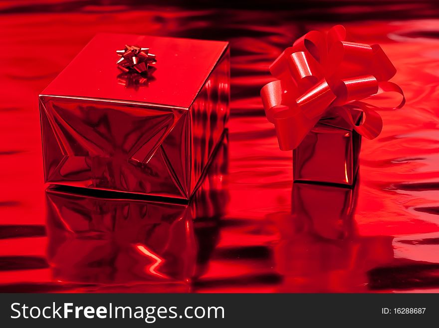 Two red christmas presents. Red background