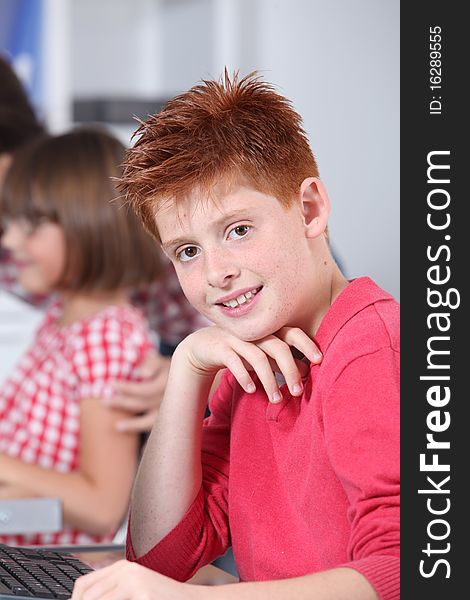 Young red-haired boy in classroom. Young red-haired boy in classroom