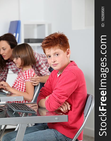 Teacher and children learning to use computer. Teacher and children learning to use computer