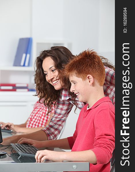 Teacher and children learning to use computer. Teacher and children learning to use computer