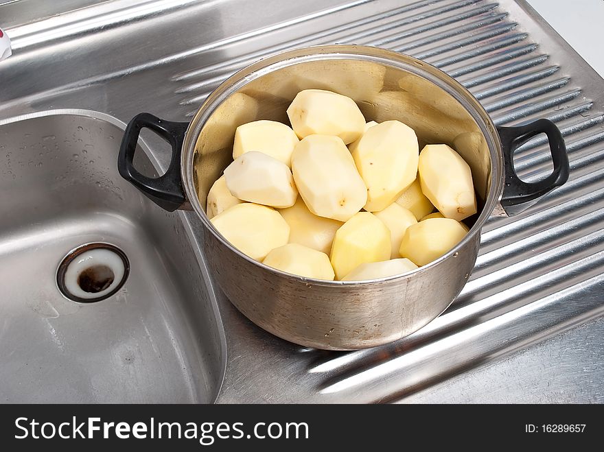 Pot with potatoes. On a kitchen. Pot with potatoes. On a kitchen