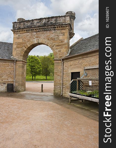Attractive stone arch in the courtyard of an English manor house