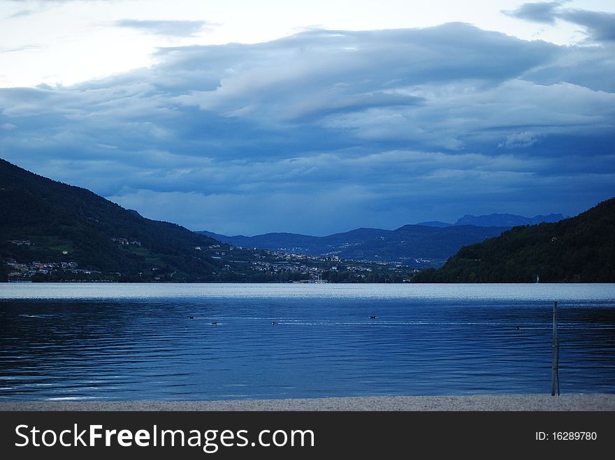 Caldonazzo's lake topped by dark clouds