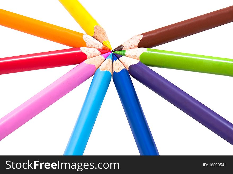 Nine different colored pencils in circle on white background, triangular shaped for correct pencil grip, shallow depth of field with focus on points. Nine different colored pencils in circle on white background, triangular shaped for correct pencil grip, shallow depth of field with focus on points