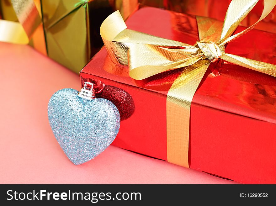 Several multi-colored gift boxes and decorative heart
