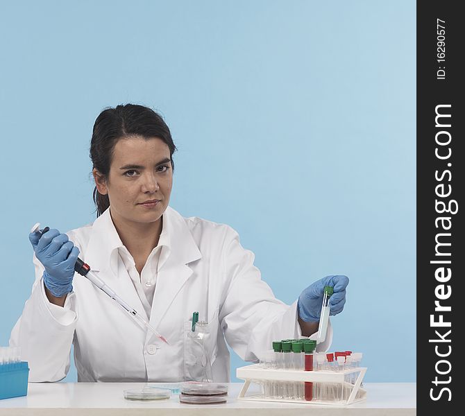 One woman scientiest sitting down while working on experiment, front view, colored background
real laboratory equipement. One woman scientiest sitting down while working on experiment, front view, colored background
real laboratory equipement