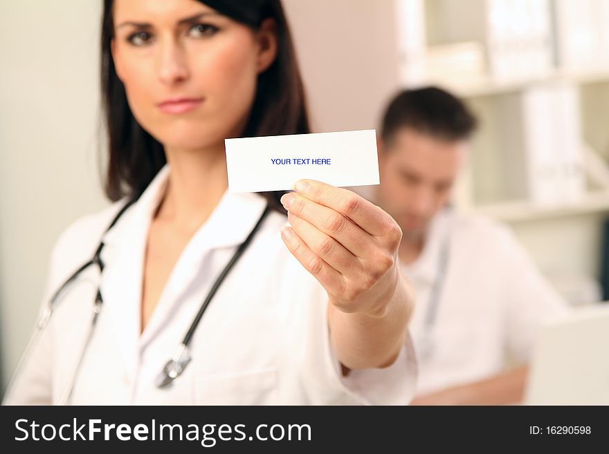 Young female doctor holding a sign. Young female doctor holding a sign
