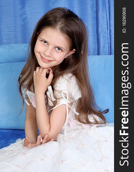 Little girl sitting in sofa