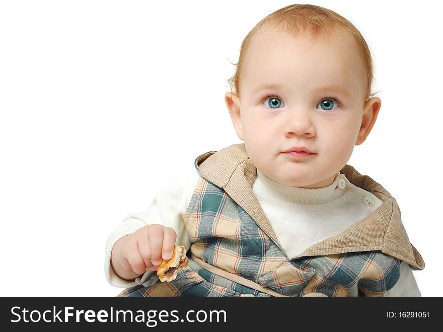 Sweet one year old baby girl with blue eyes with a cookie in her hand isolated on a white background. Sweet one year old baby girl with blue eyes with a cookie in her hand isolated on a white background