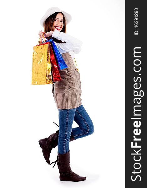 Side view of woman carrying shopping bags against an isolated background. Side view of woman carrying shopping bags against an isolated background
