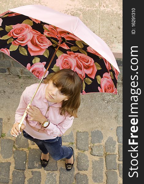 Girl with a pink umbrella on the street. Girl with a pink umbrella on the street