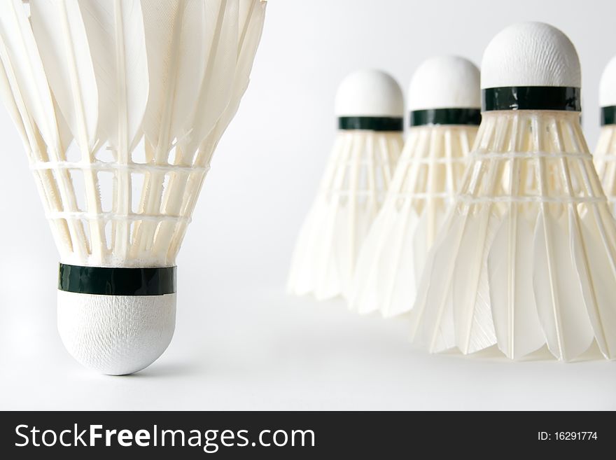 Close-up of white badminton shuttlecocks on light background