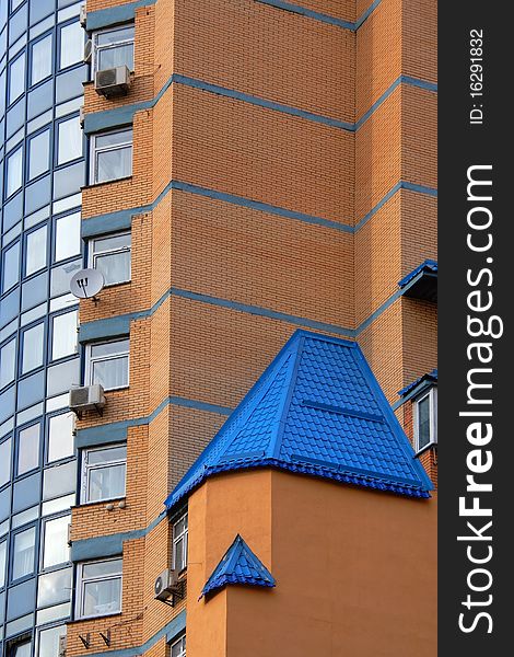 Facade of new, just populated brick house with blue roof. Facade of new, just populated brick house with blue roof