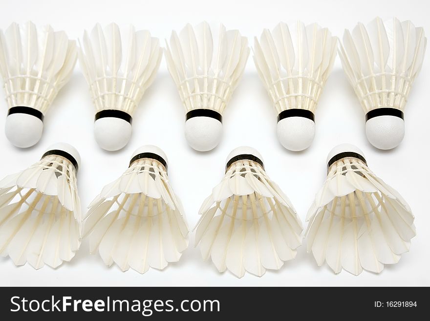 Two rows of badminton shuttlecocks on white background. Two rows of badminton shuttlecocks on white background