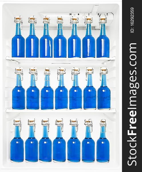 Bottles with blue liquid in a fridge. Bottles with blue liquid in a fridge