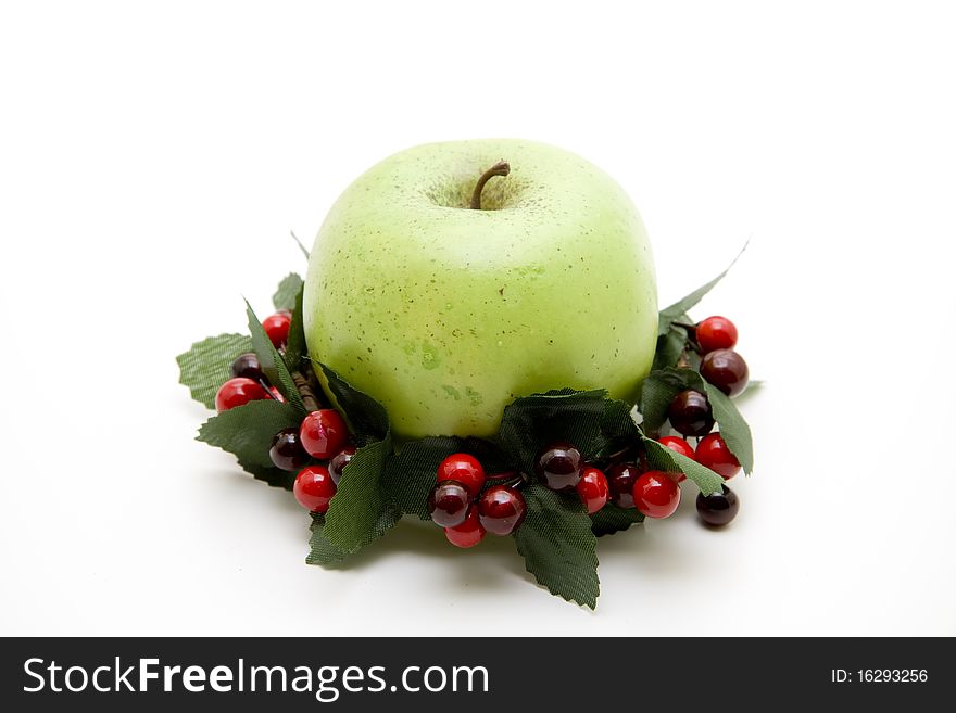 Green wreath with red berries and apple. Green wreath with red berries and apple