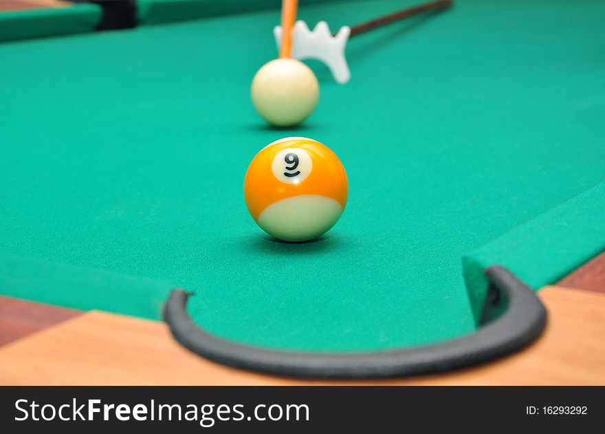 Billiard balls on a green billiard table