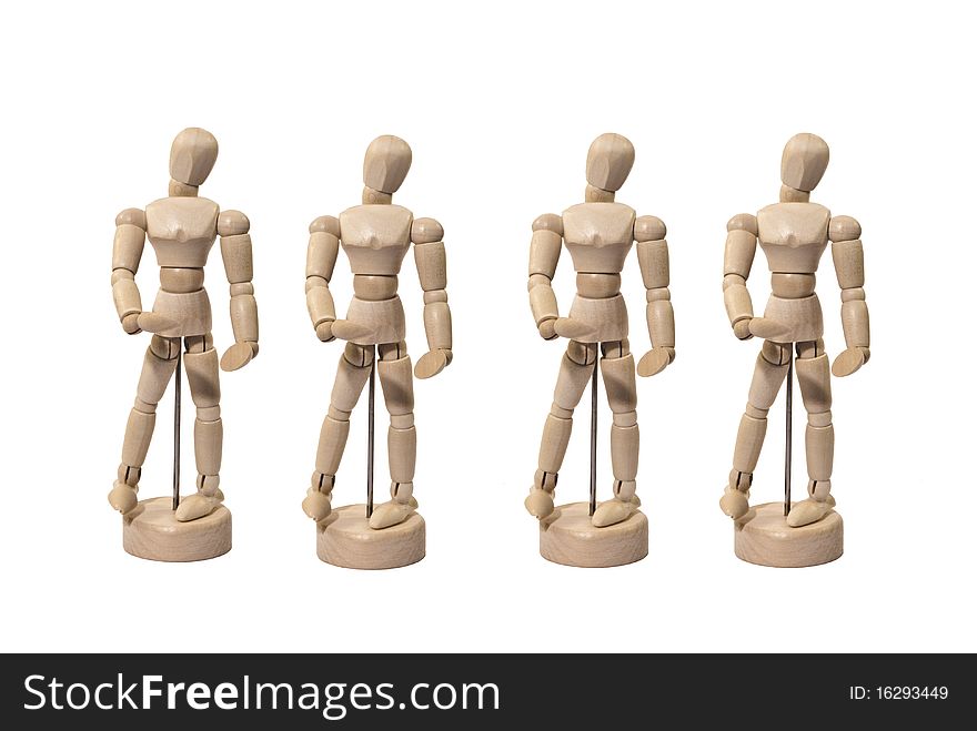 Four Identical Wooden Artist Dummies in a Line-up Isolated on White. Four Identical Wooden Artist Dummies in a Line-up Isolated on White