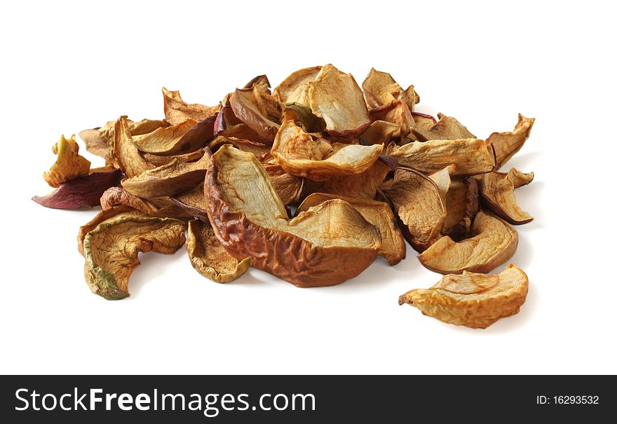 Dried apples are heaped on a white background. Dried apples are heaped on a white background