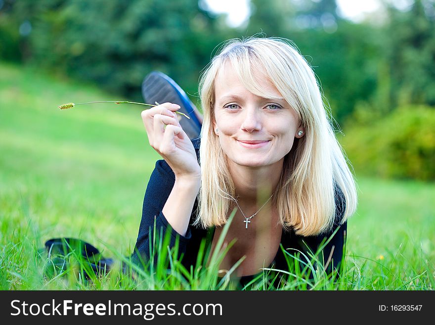 Girl relaxing on the meadow against