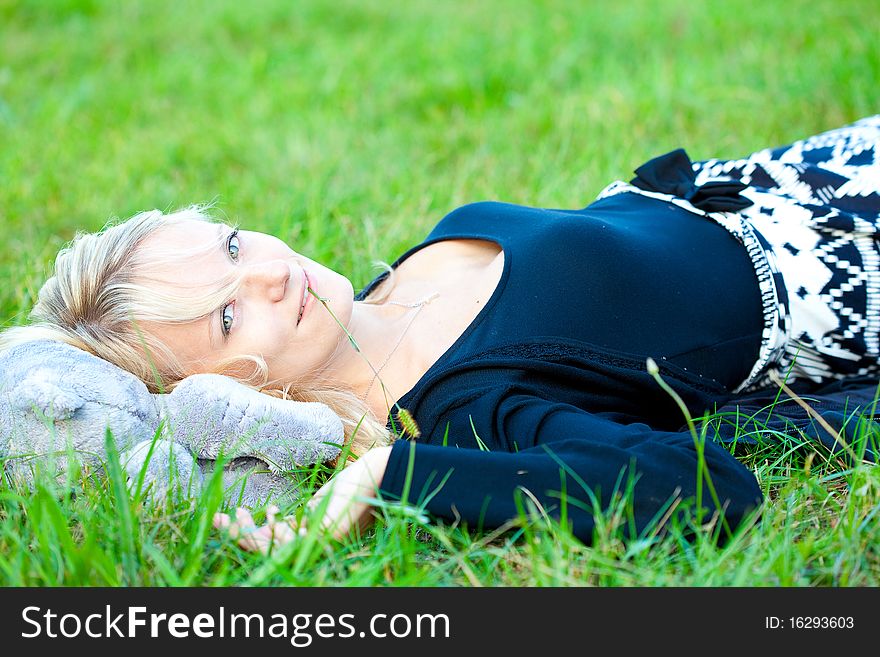 Girl relaxing on the meadow against