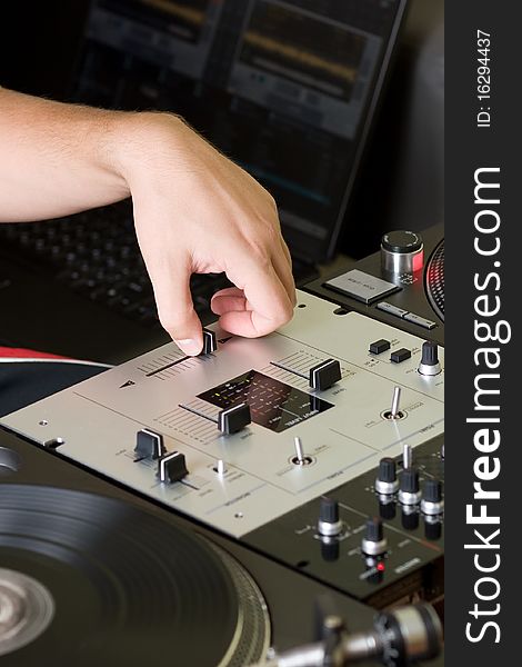 Hand of a disc jockey on the professional mixing controller. Hand of a disc jockey on the professional mixing controller