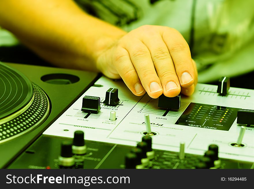 Hand of a disc jockey on the professional mixing controller. Hand of a disc jockey on the professional mixing controller