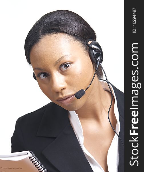 An african american business woman dressed formally uses a headset, isolated on white