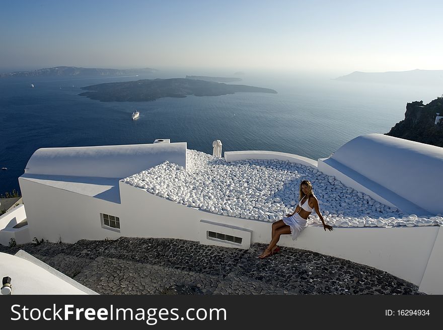 Young woman admires the sunset in Santorini, Greece. Young woman admires the sunset in Santorini, Greece