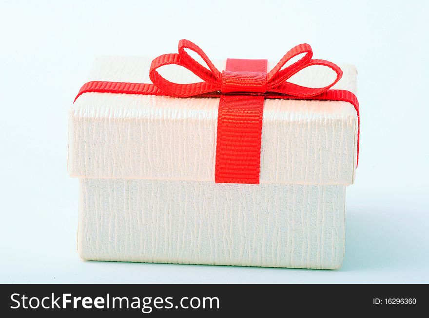 White gift box with red ribbon