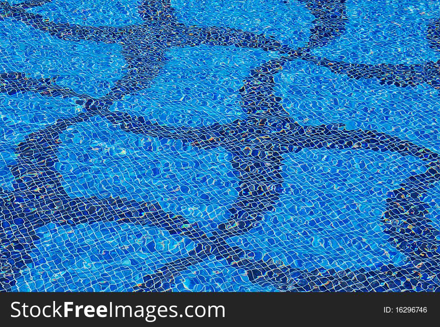 Transparent fresh water with mosaic star shape at bottom of swimming pool. Transparent fresh water with mosaic star shape at bottom of swimming pool