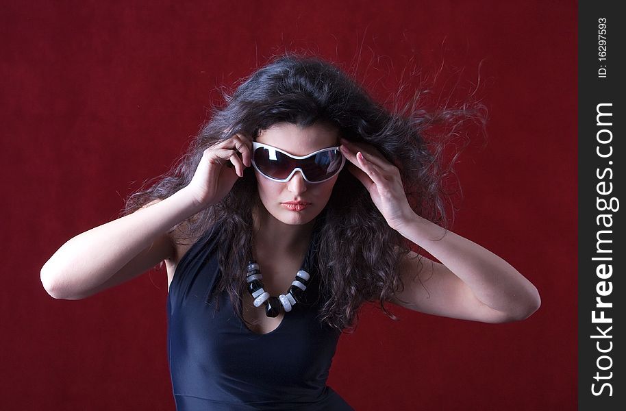 Portrait of hot fashion model wearing sunglasses commercial expression