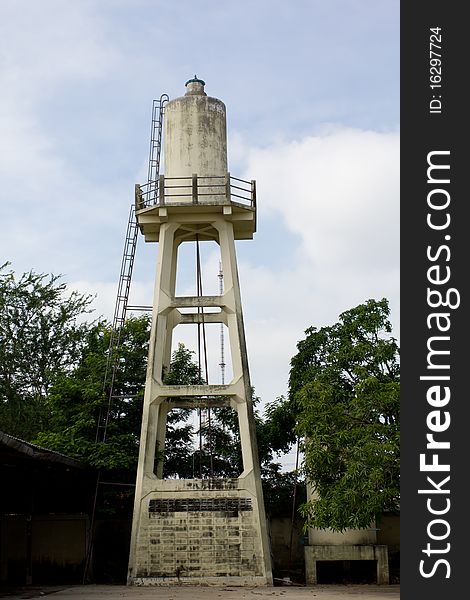 Old abandoned industrial water tower with reservoir tank in factory