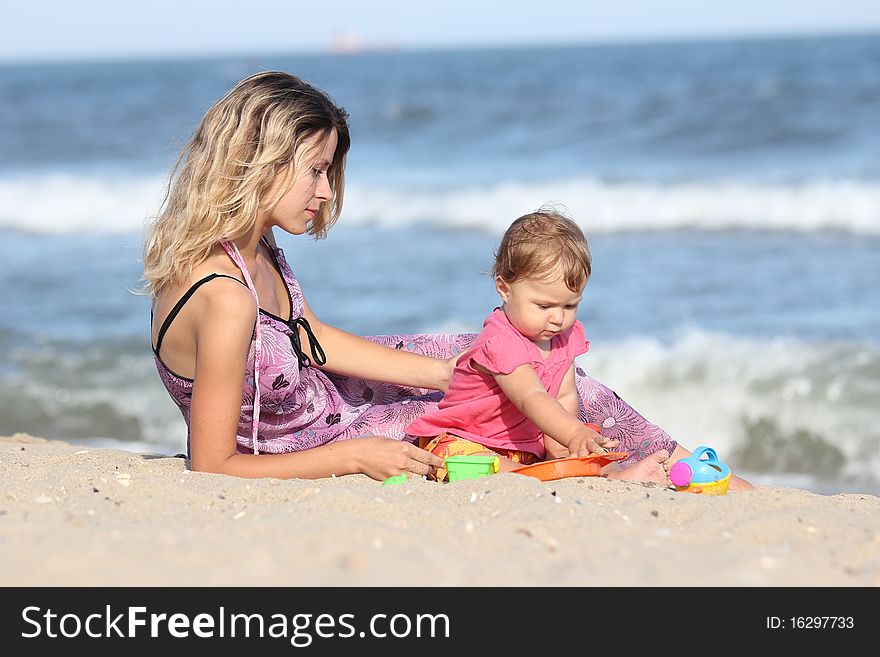 Mom with a child playing in the sand