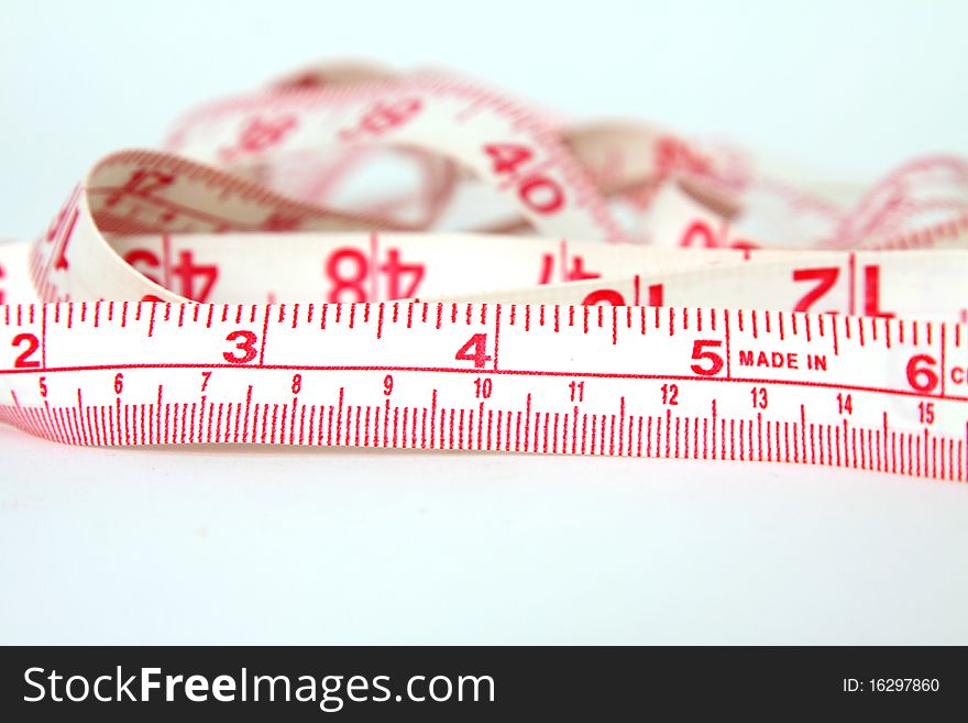 Measuring tape with red markings on white background. Measuring tape with red markings on white background