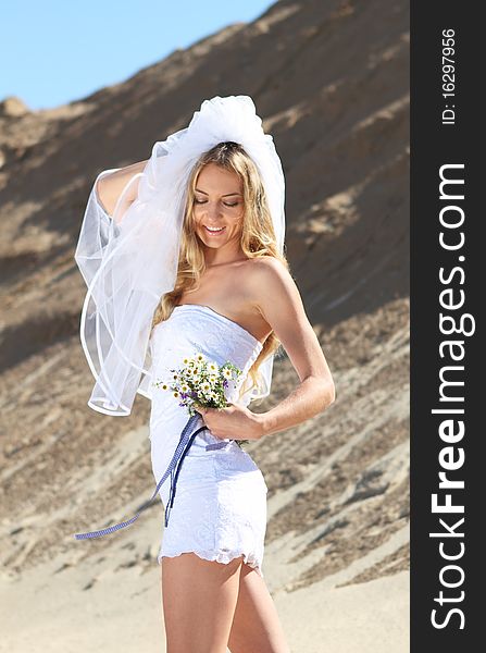 Beautiful bride in her white dress on a windy summer day. Beautiful bride in her white dress on a windy summer day