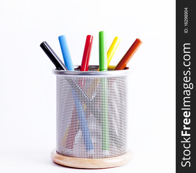 Black metal pencil cup filled with colorful pencils.