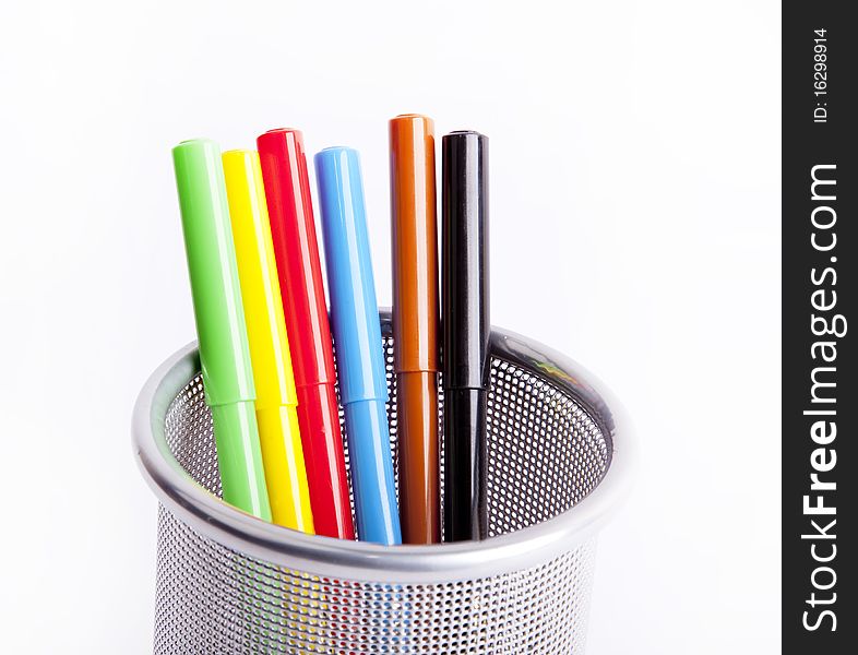 Black pencil cup filled with colorful pencils.