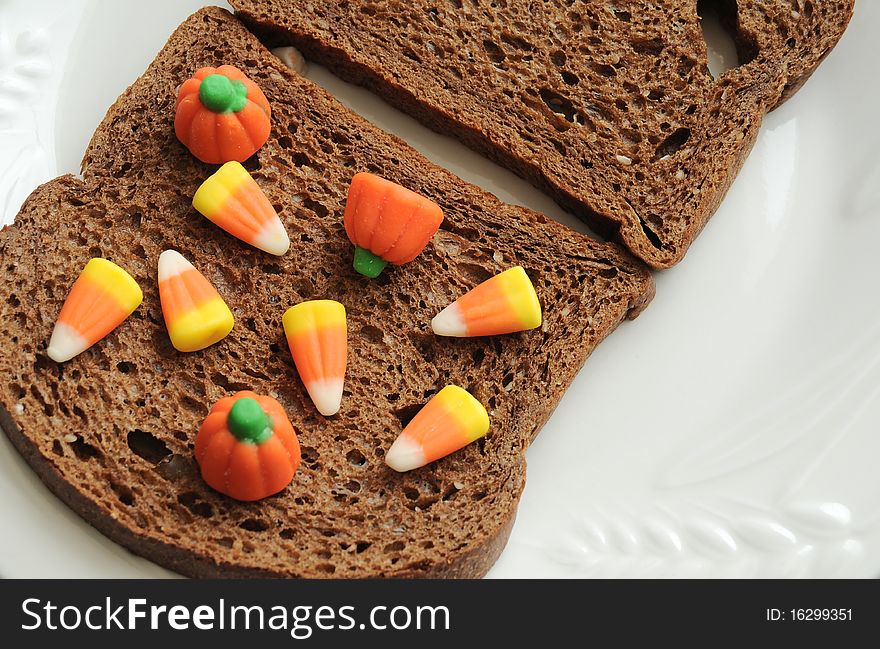 An unhealthy halloween snack. A candy corn and bread sandwich!