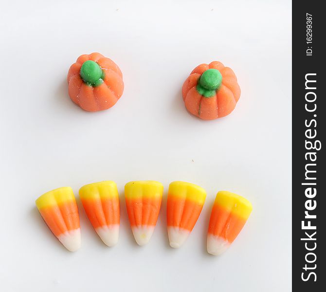 Sweet halloween Candy Corn isolated on a white background arranged in a scary pumpkin face. Sweet halloween Candy Corn isolated on a white background arranged in a scary pumpkin face