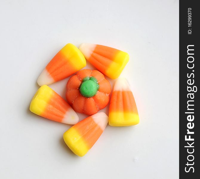 A pile of Halloween candy corn on a white background.