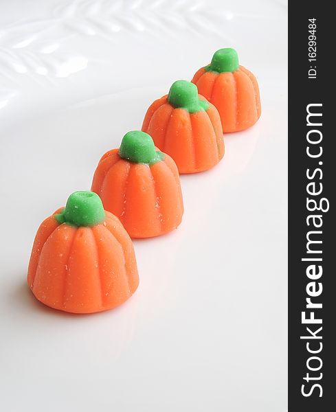 Row of sweet halloween candy pumpkins on white background. Row of sweet halloween candy pumpkins on white background