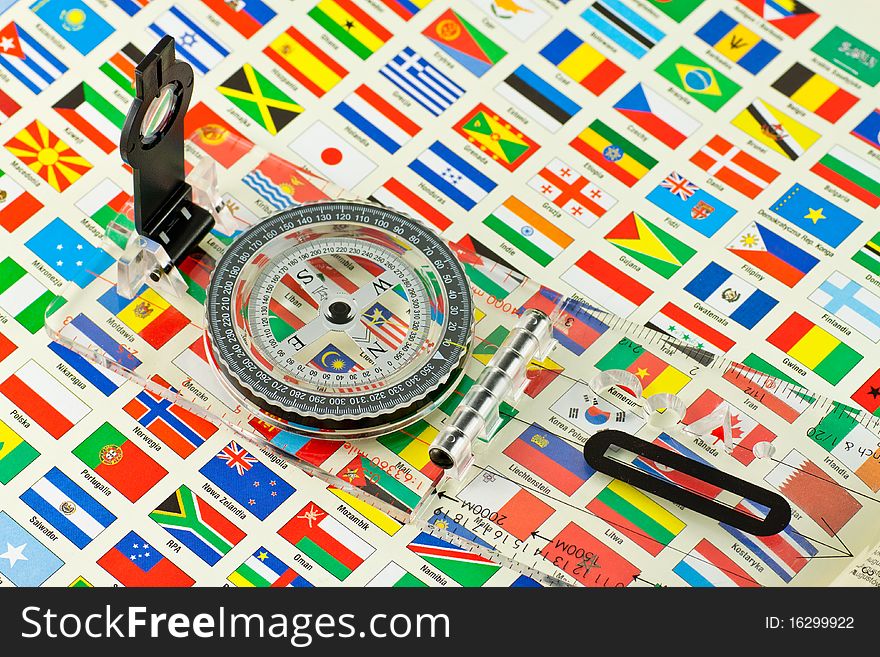 Compass on the background of many flags. Compass on the background of many flags