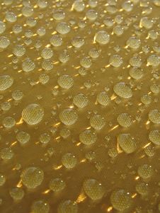 Rain Drops At Yellow Surface With  Sunny Glare Royalty Free Stock Photography