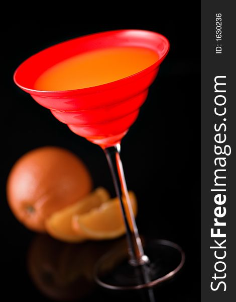 Orange juice in red glass