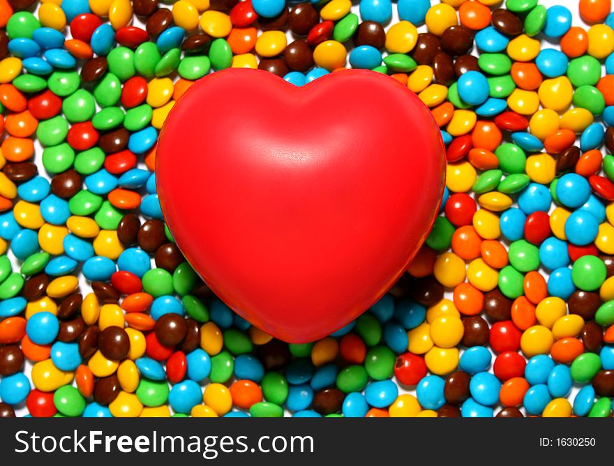 Colorful candy background with a red heart from my Valentine series. Colorful candy background with a red heart from my Valentine series