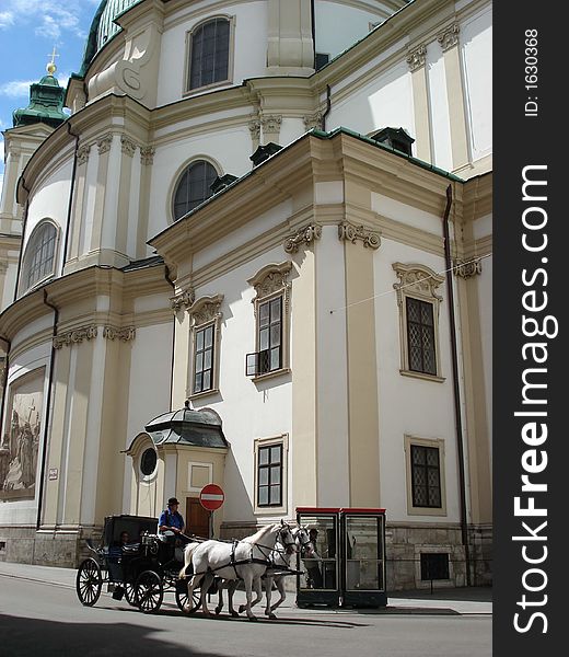 Carriage and horses in front of the churc in Vienna, Austria